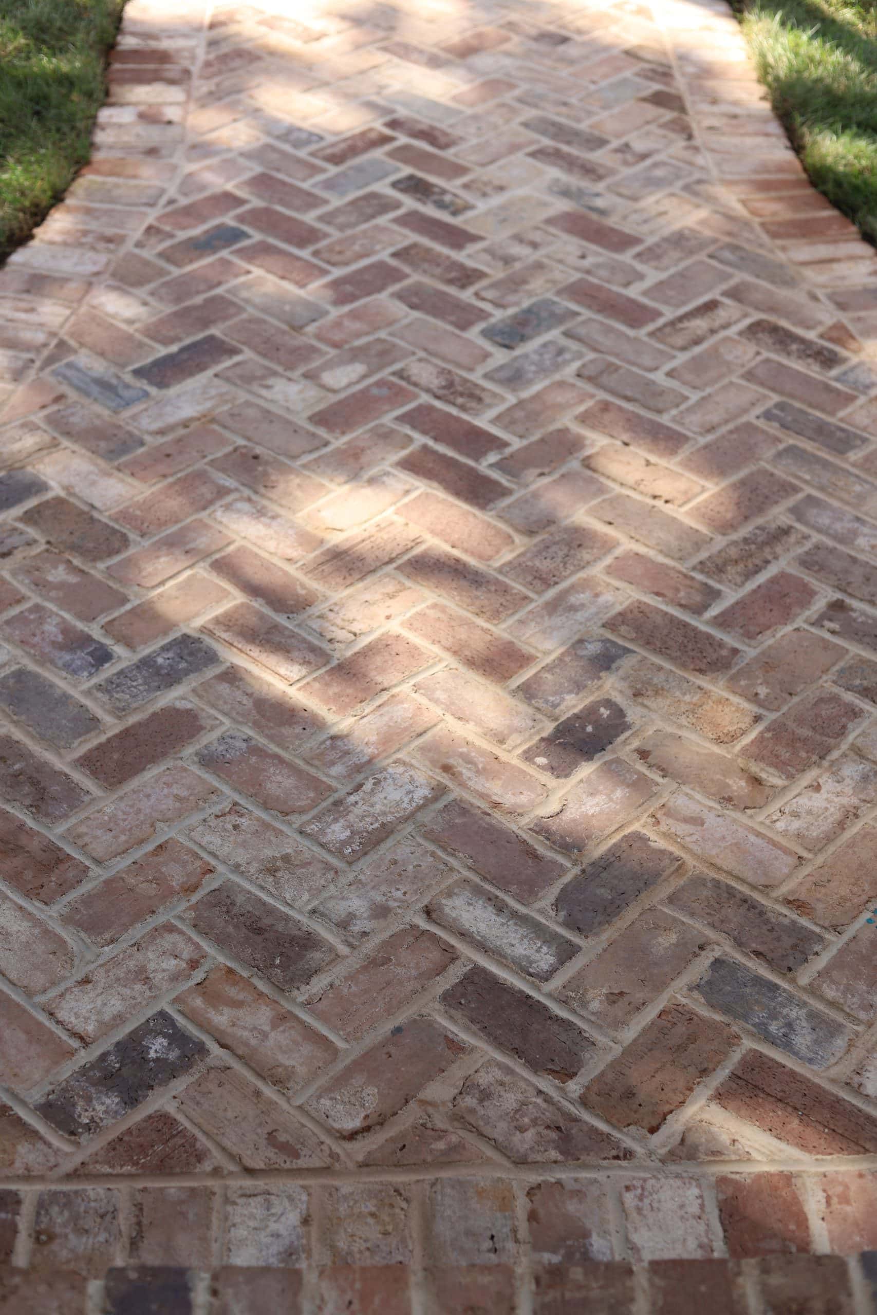 Herringbone pattern brick walkway detail with boxwood border at Highland & Morningside estate garden, Atlanta