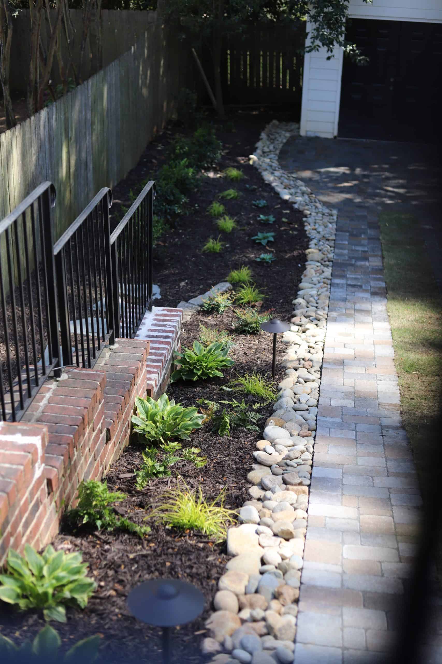 Landscape lighting along paver walkway with river rock border and shade planting beds at the Healy Project, Chastain Park, Atlanta by Garden Atlantic