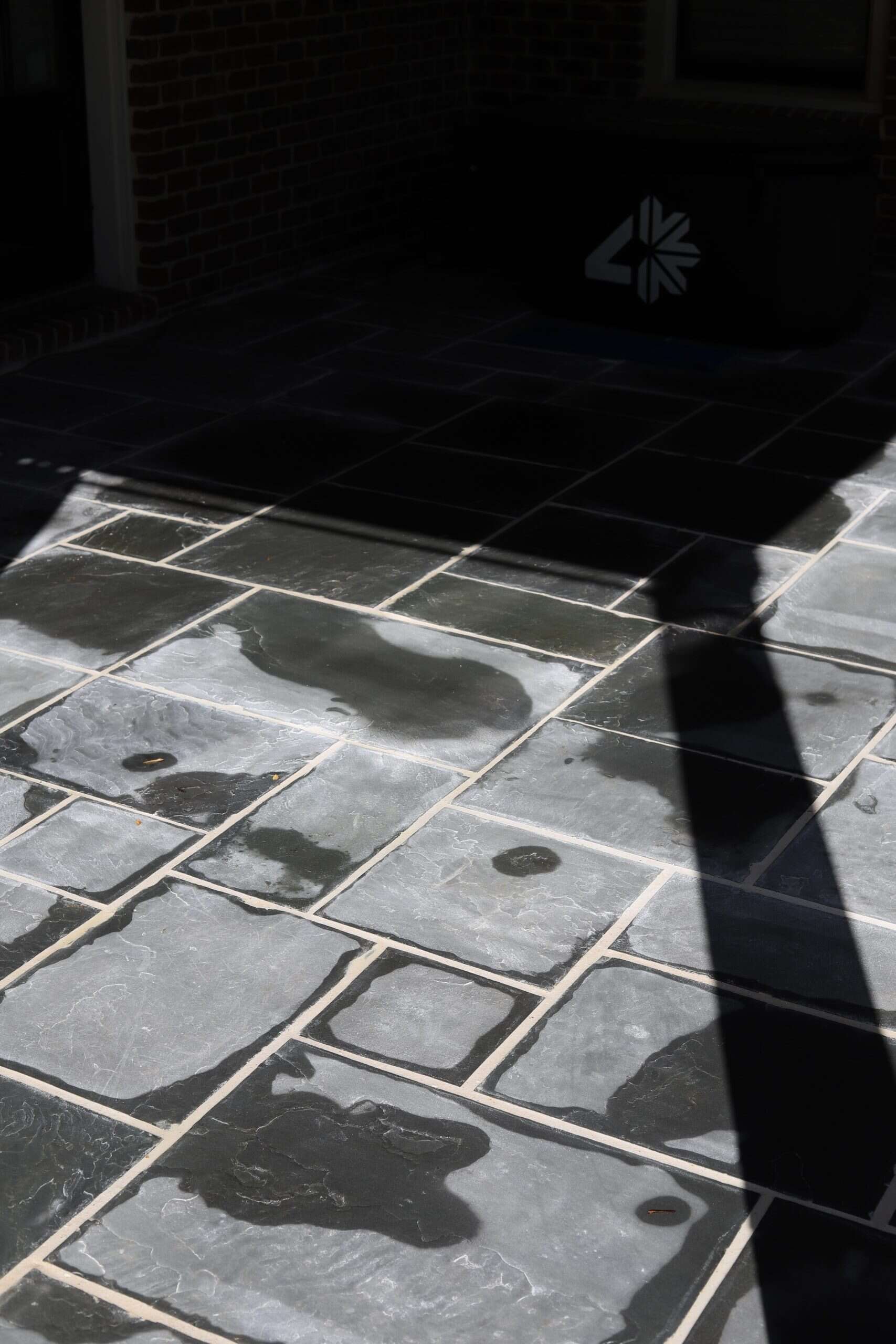 Natural stone patio detail with herringbone pattern and contrasting grout joints at the Healy Project, Chastain Park, Atlanta by Garden Atlantic